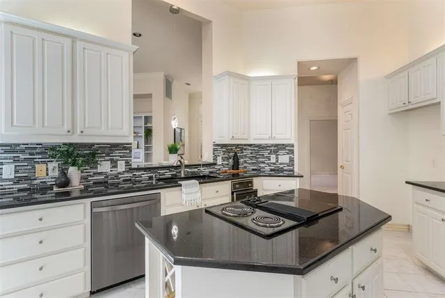 a kitchen with stainless steel appliances granite countertop a sink stove and cabinets