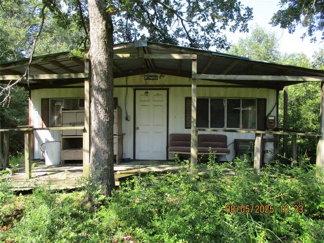 a backyard of a house with table and chairs