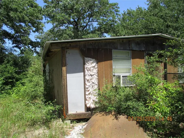 a side view of a house with a small yard