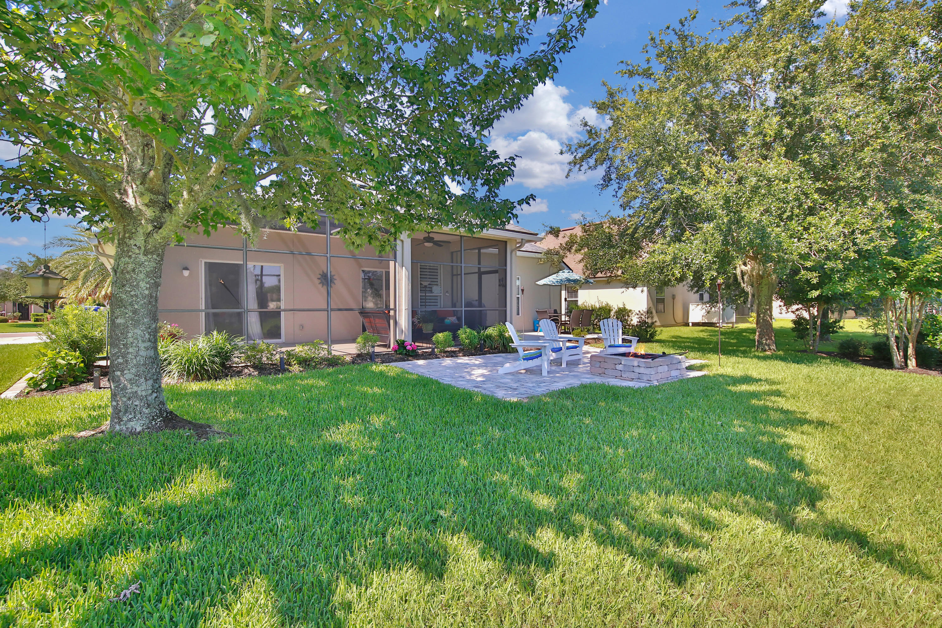 712 Porta Rosa Circle St. Augustine, FL 32092 - Photo 25 of 34 a front view of a house with garden and trees