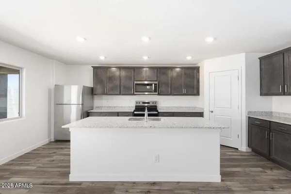 a view of an empty room and wooden floor