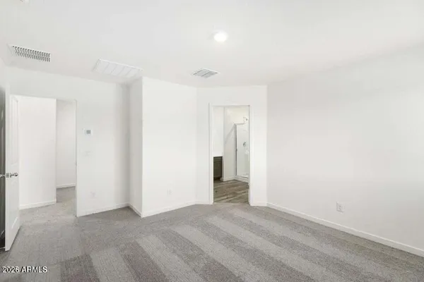 a view of a room with wooden floor and white walls