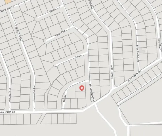 a view of a swimming pool with a garden and trees