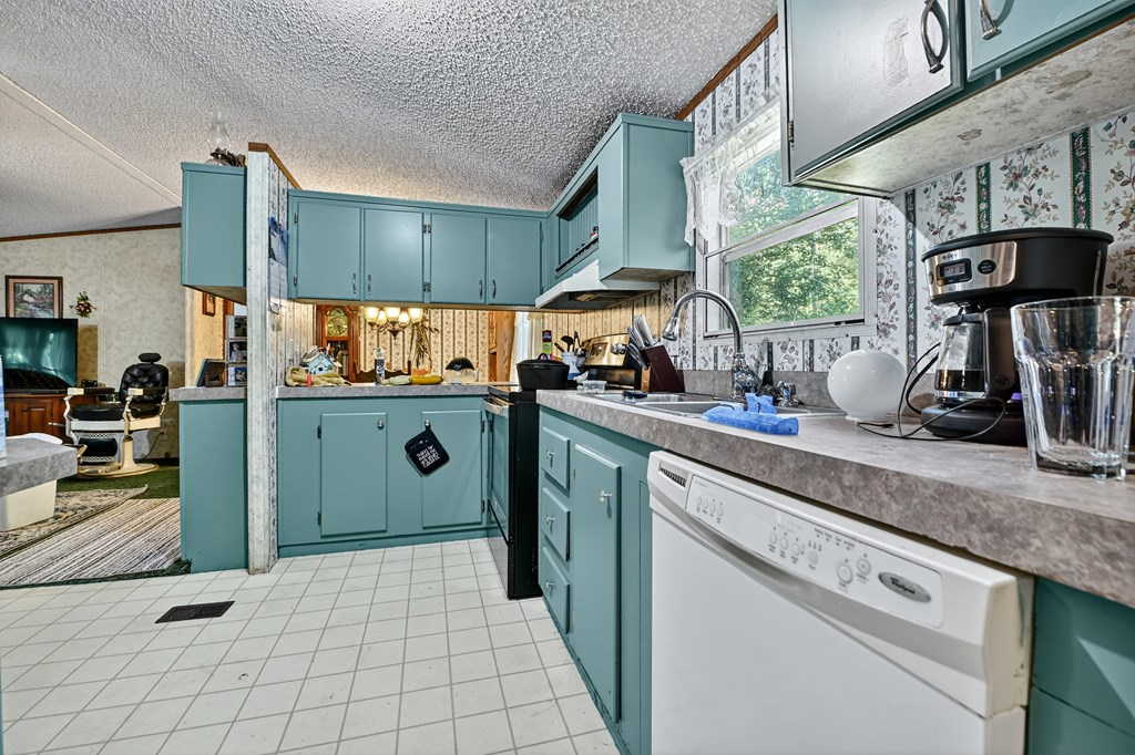 354 Circle Drive Blue Ridge, GA 30513 - Photo 15 of 41 a kitchen with stainless steel appliances granite countertop a sink stove and cabinets