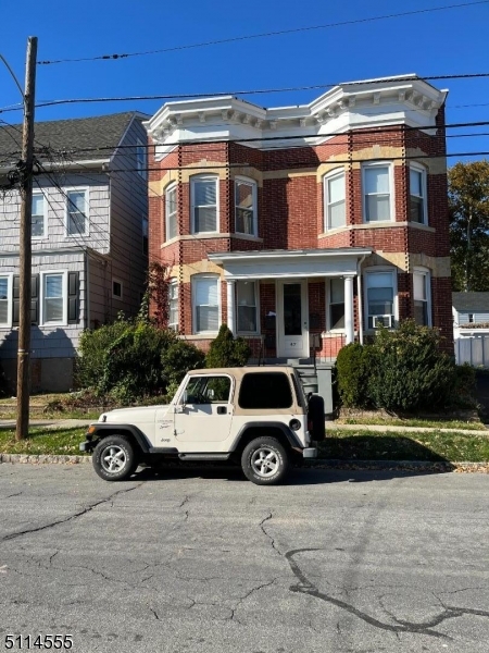 47 Park Avenue, Unit 2 Summit, NJ 07901 - Photo 1 of 1 a car parked in front of a white house