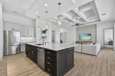 a kitchen with stainless steel appliances granite countertop a sink stove and refrigerator