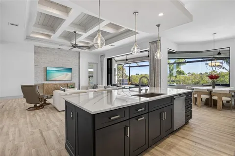 a kitchen with a sink and wooden floor