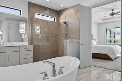 a bathroom with a tub sink and shower