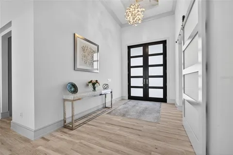 a view of a bedroom with wooden floor and windows