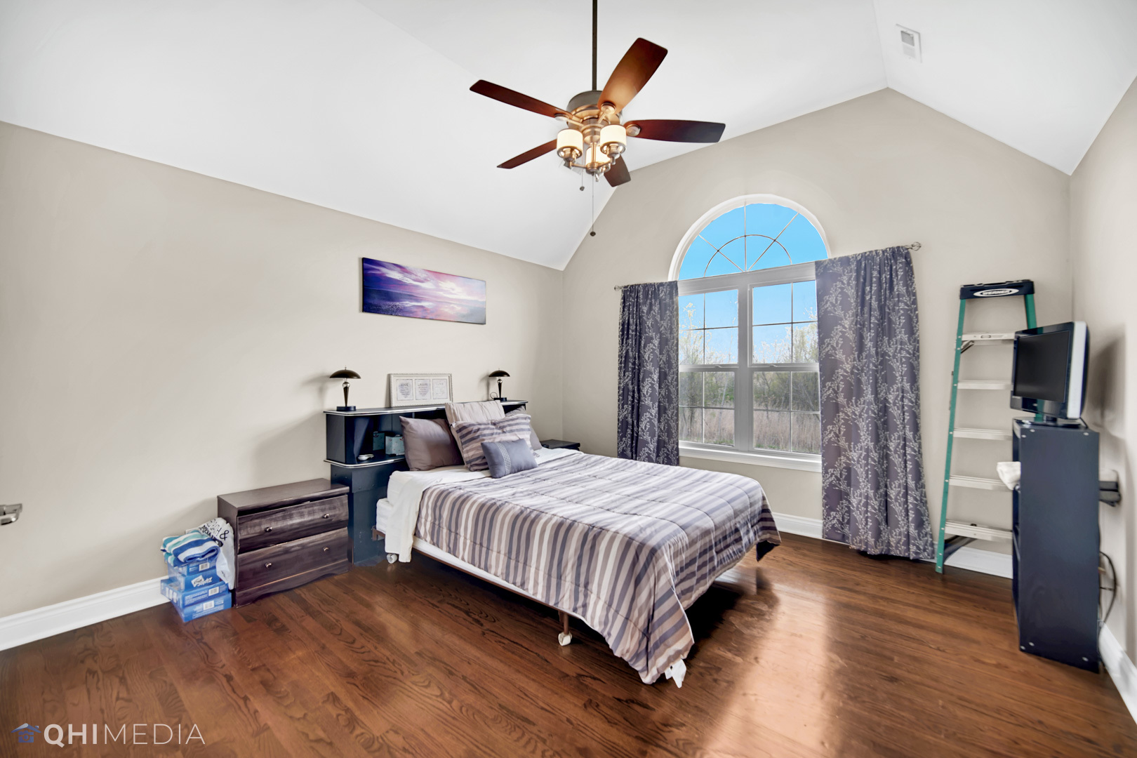 Undisclosed Address Steger, IL 60475 - Photo 18 of 29 a bedroom with a bed and a chandelier