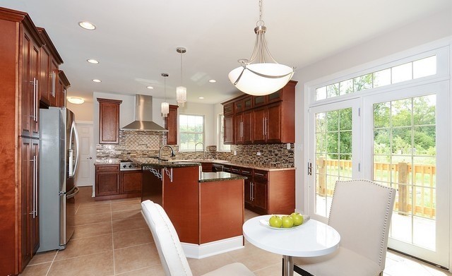 Undisclosed Address Steger, IL 60475 - Photo 7 of 29 a kitchen with stainless steel appliances granite countertop a stove a refrigerator a kitchen island a sink a stove a dining table and chairs