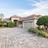 a front view of a house with a yard and trees