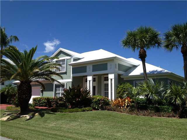 4259 Rigels Cove Way Jensen Beach, FL 34957 - Photo 1 of 22 a front view of a house with a yard and potted plants
