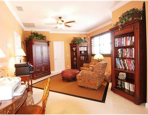 4259 Rigels Cove Way Jensen Beach, FL 34957 - Photo 13 of 22 a bedroom with furniture and a book shelf