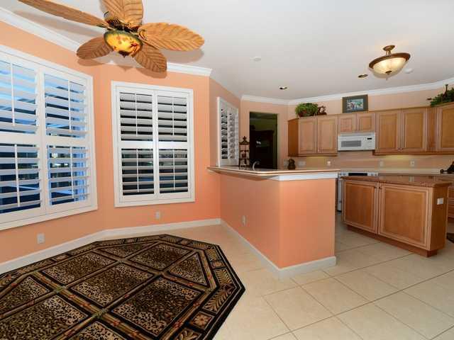 4259 Rigels Cove Way Jensen Beach, FL 34957 - Photo 17 of 22 a kitchen with stainless steel appliances granite countertop a stove a sink and a refrigerator