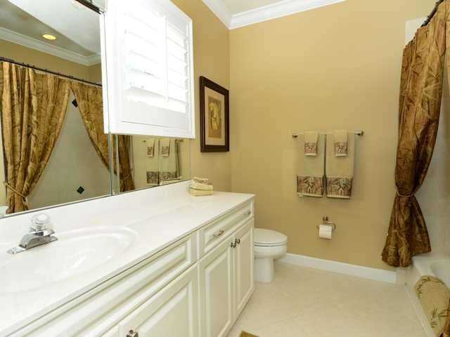 4259 Rigels Cove Way Jensen Beach, FL 34957 - Photo 19 of 22 a bathroom with a sink a toilet and a mirror