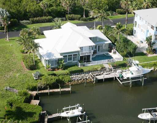 4259 Rigels Cove Way Jensen Beach, FL 34957 - Photo 22 of 22 an aerial view of a house with a lake view