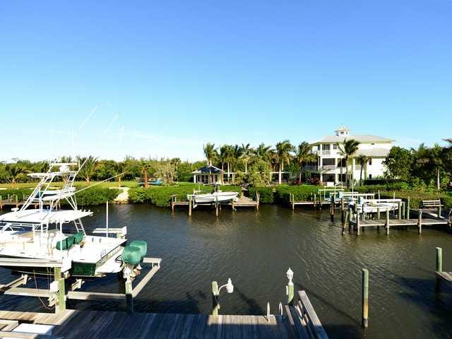 4259 Rigels Cove Way Jensen Beach, FL 34957 - Photo 4 of 22 a view of a lake with boats and trees in the background