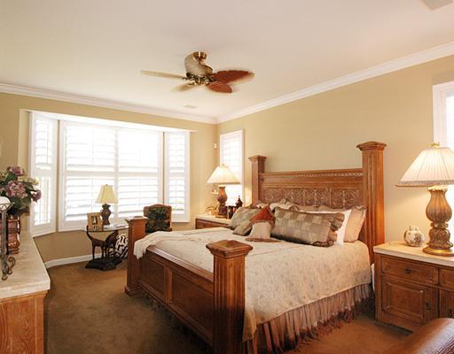 4259 Rigels Cove Way Jensen Beach, FL 34957 - Photo 8 of 22 a bedroom with bed and large windows