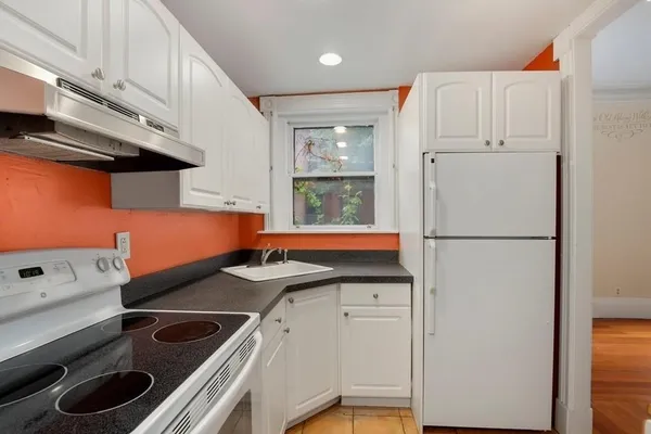 a kitchen with a sink and a refrigerator