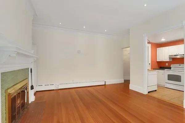 a view of a kitchen with wooden floor and a sink