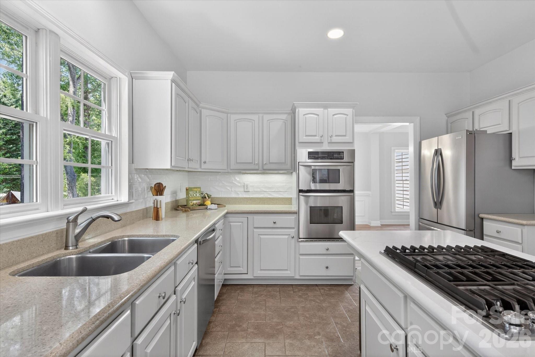 8528 Headford Road Charlotte, NC 28277 - Photo 11 of 34 a kitchen with stainless steel appliances granite countertop a sink stove and refrigerator