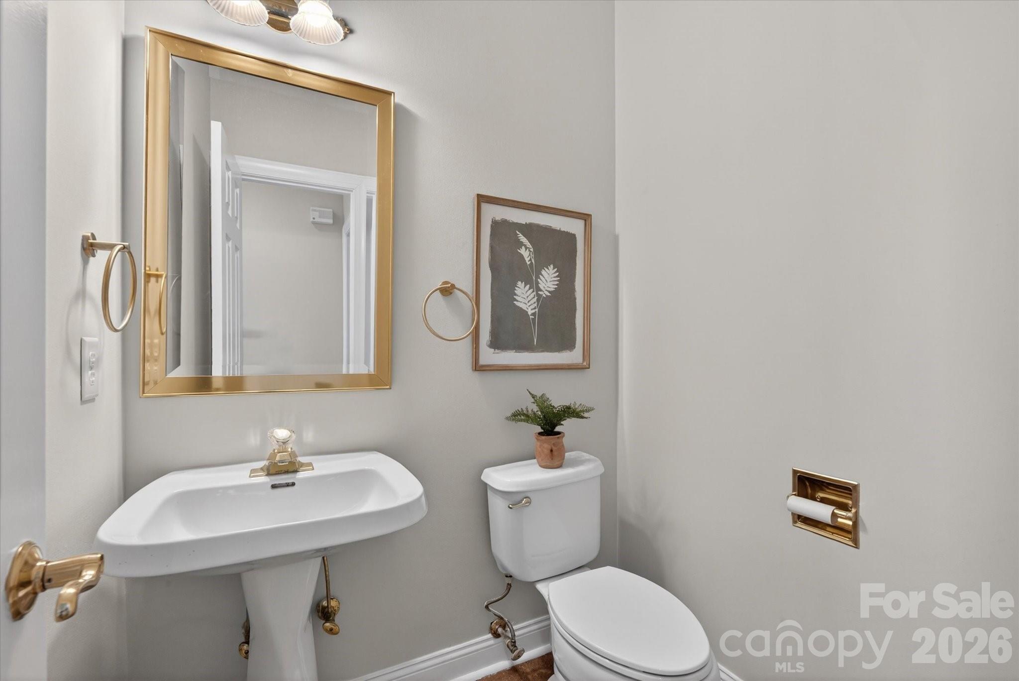 8528 Headford Road Charlotte, NC 28277 - Photo 12 of 34 a bathroom with a toilet sink and mirror