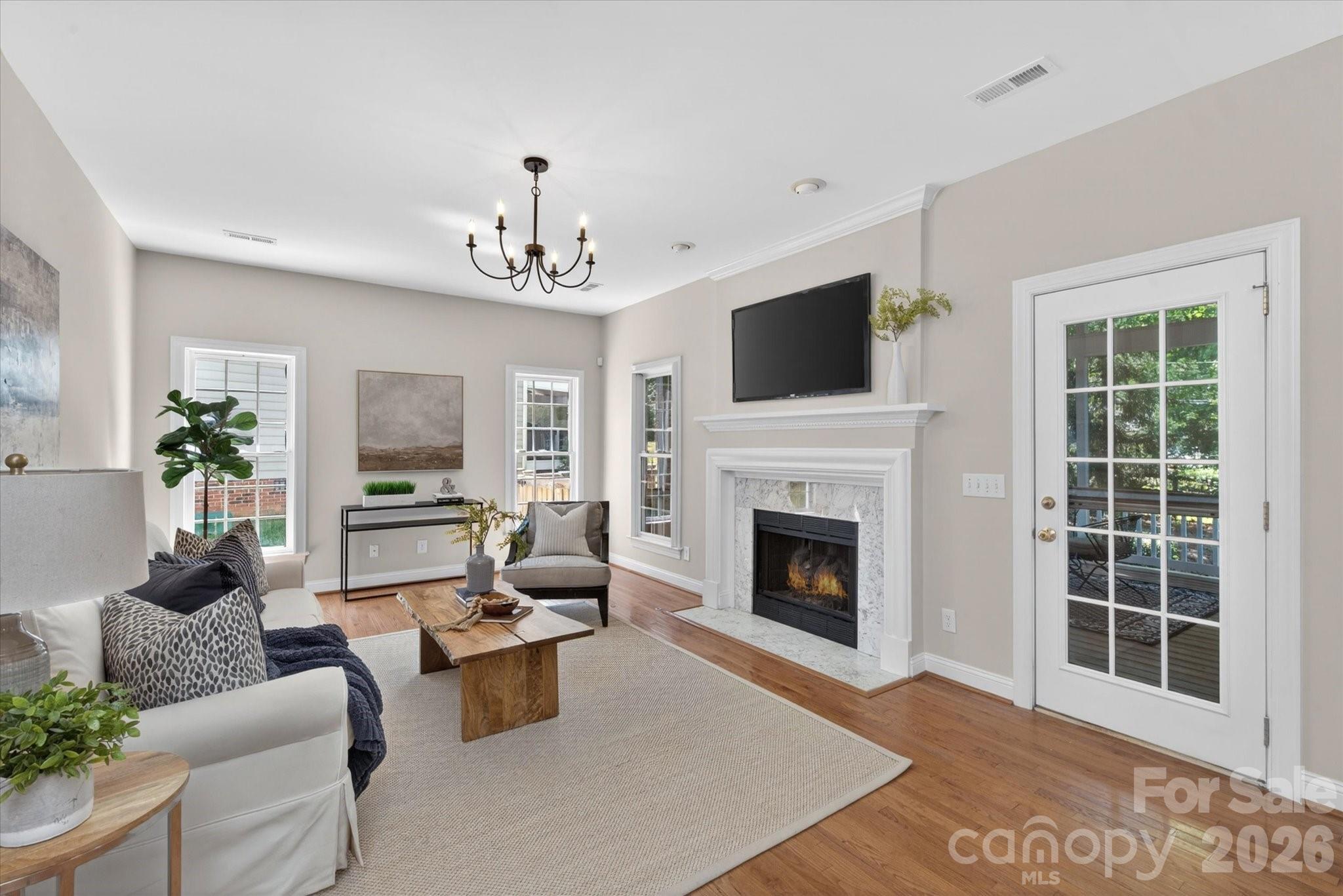 8528 Headford Road Charlotte, NC 28277 - Photo 13 of 34 a living room with furniture a fireplace and a flat screen tv