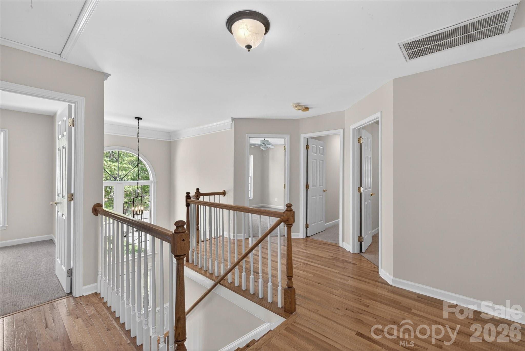 8528 Headford Road Charlotte, NC 28277 - Photo 17 of 34 a view of a hallway with wooden floor and stairs