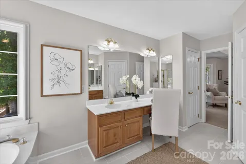a large bathroom with a double vanity sink a mirror and a shower