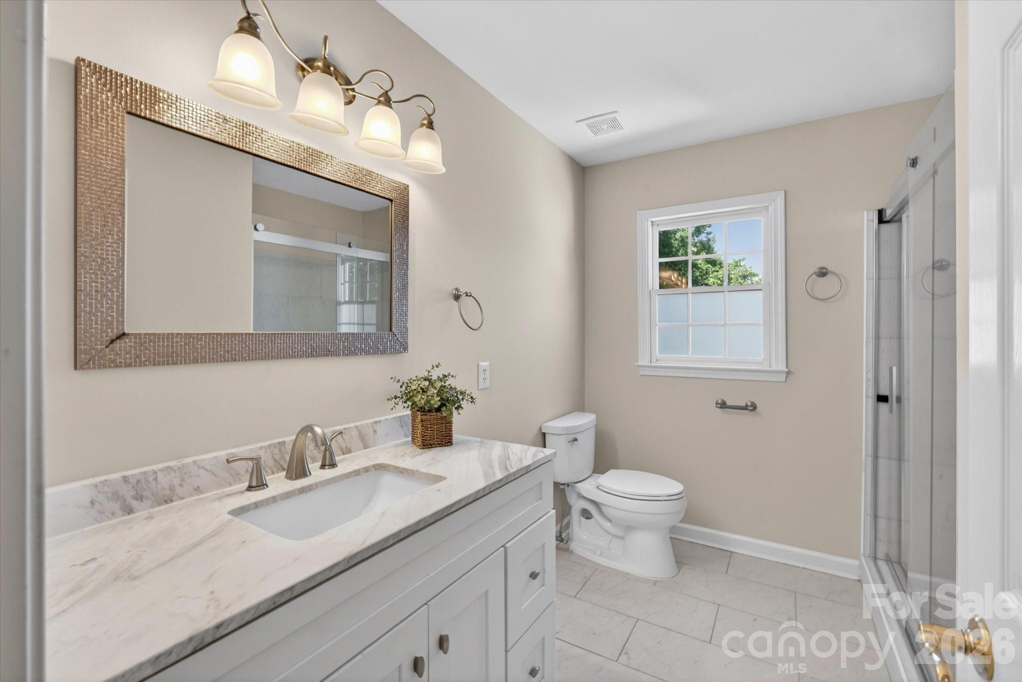 8528 Headford Road Charlotte, NC 28277 - Photo 24 of 34 a bathroom with a granite countertop sink mirror and toilet