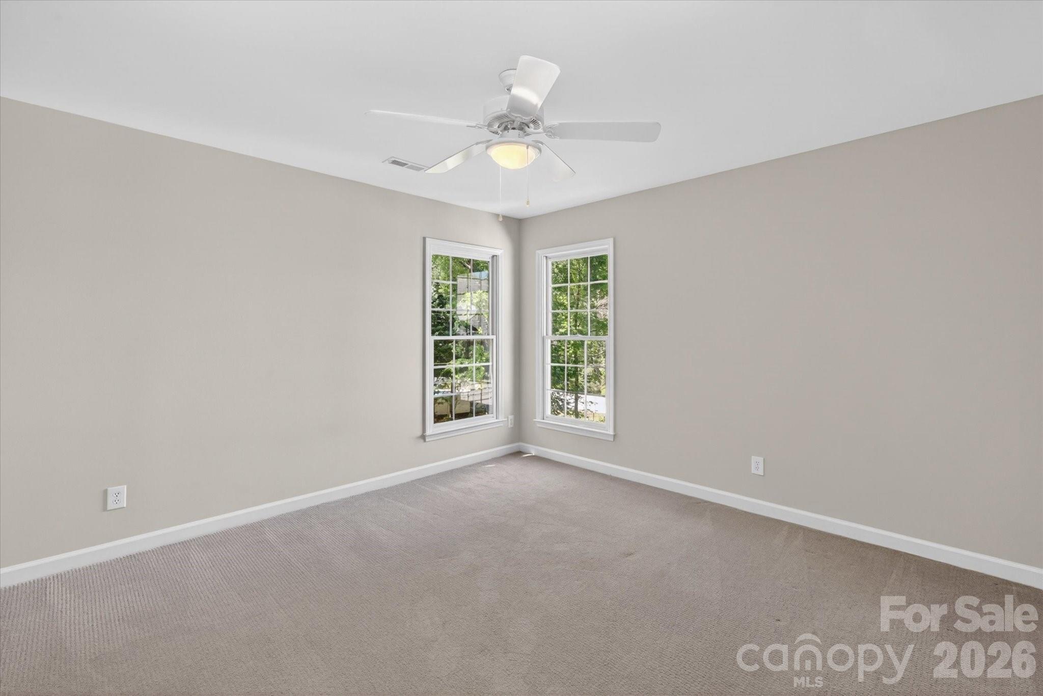 8528 Headford Road Charlotte, NC 28277 - Photo 25 of 34 an empty room with windows and ceiling fan