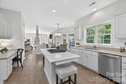 a large kitchen with a table and chairs in it