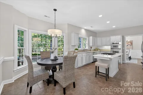 a kitchen with counter space and windows
