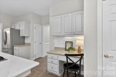 a kitchen with stainless steel appliances a stove a refrigerator and cabinets