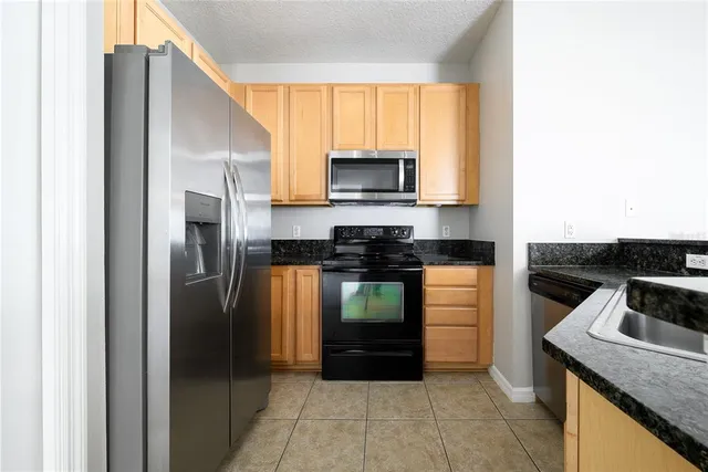a kitchen with a refrigerator stove and microwave