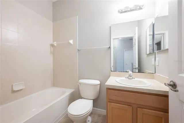 a bathroom with a toilet a sink a mirror a bathtub and shower