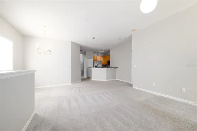 an empty room with windows and fireplace