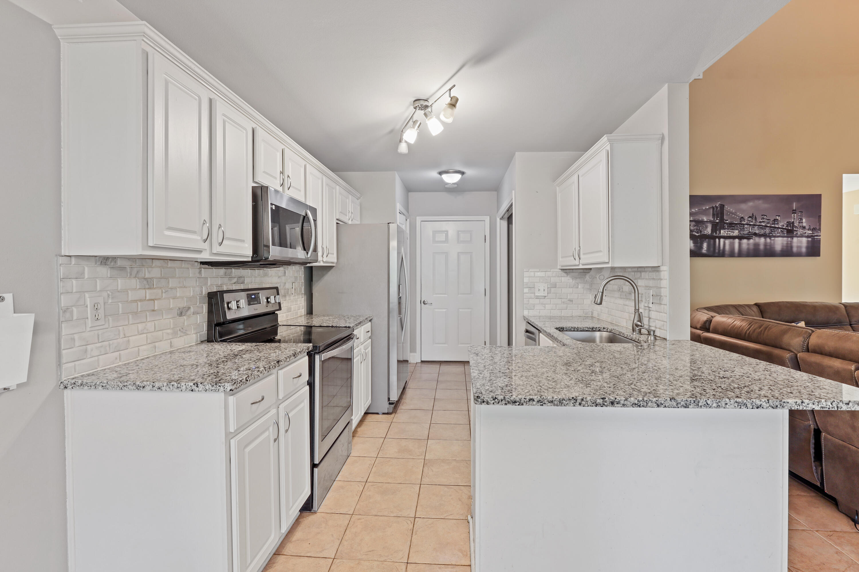 90 Hidden Lakes Drive Miramar Beach, FL 32550 - Photo 5 of 18 a kitchen with stainless steel appliances granite countertop a sink stove and cabinets
