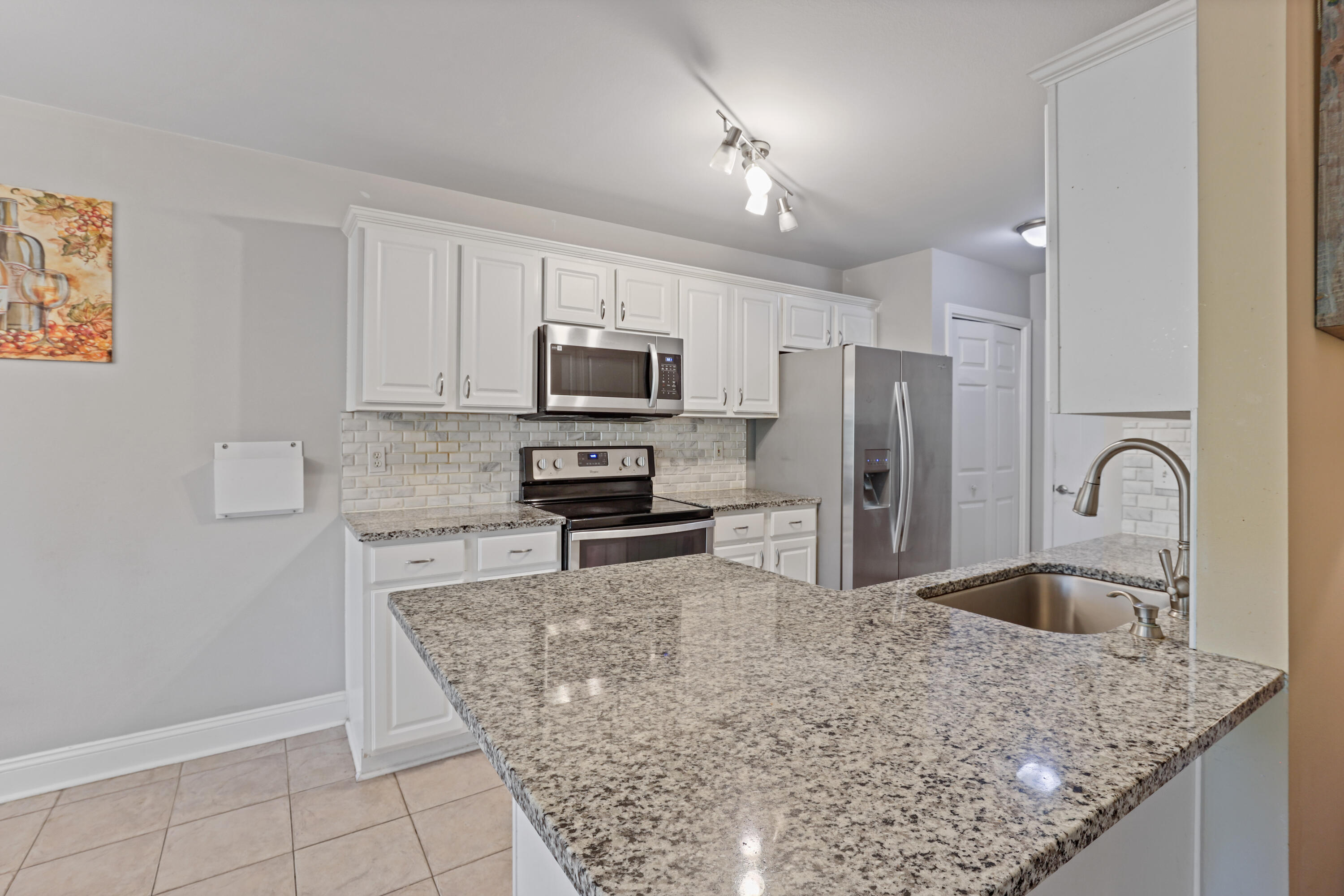 90 Hidden Lakes Drive Miramar Beach, FL 32550 - Photo 6 of 18 a kitchen with stainless steel appliances granite countertop a sink stove and refrigerator