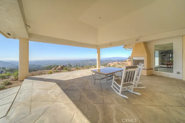 a view of a room with gym equipment and white walls