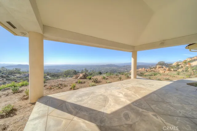 a view of empty room with projector and fan