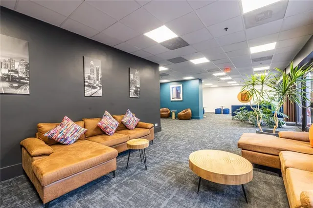 a living room with furniture and a potted plant