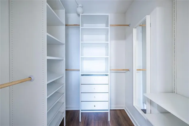 a view of walk in closet with empty racks