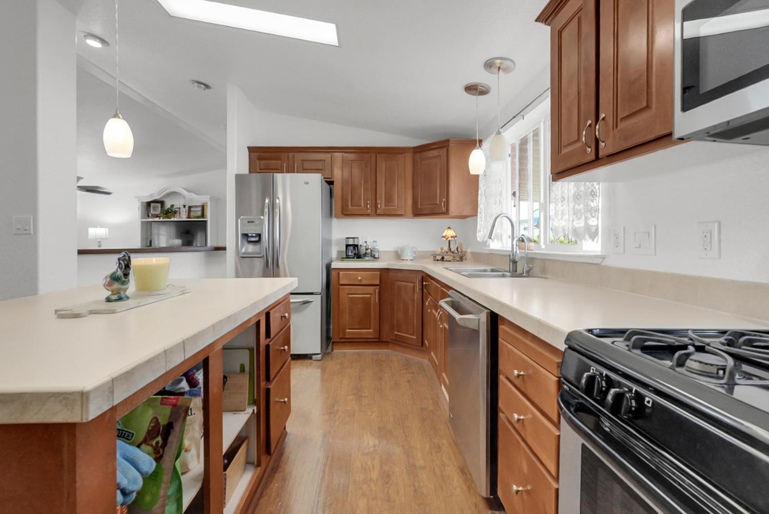 1459 Standiford, Unit 92 Modesto, CA 95350 - Photo 14 of 19 a kitchen with stainless steel appliances a sink a stove and cabinets