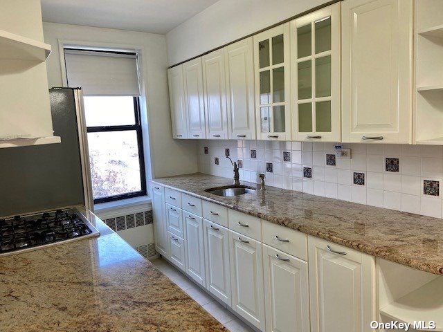 a kitchen with granite countertop sink stainless steel appliances and cabinets