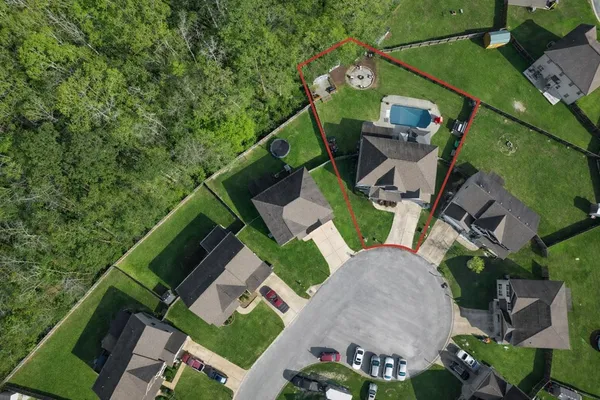 a front view of a house with a garden and yard