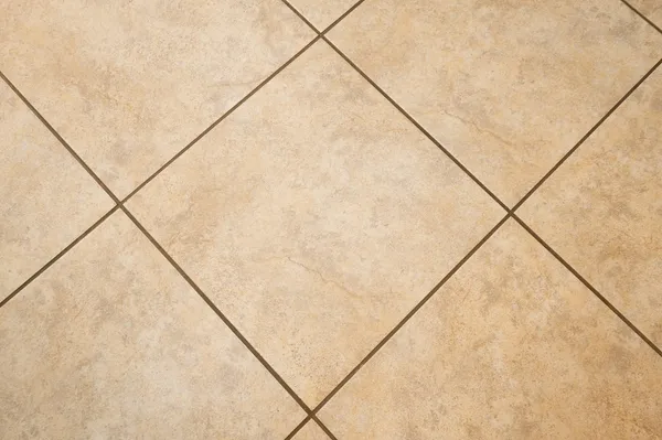 an empty room with wooden floor fireplace and windows