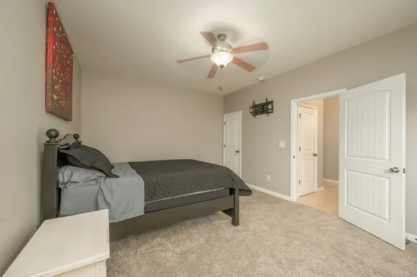 an empty room with a window and a ceiling fan
