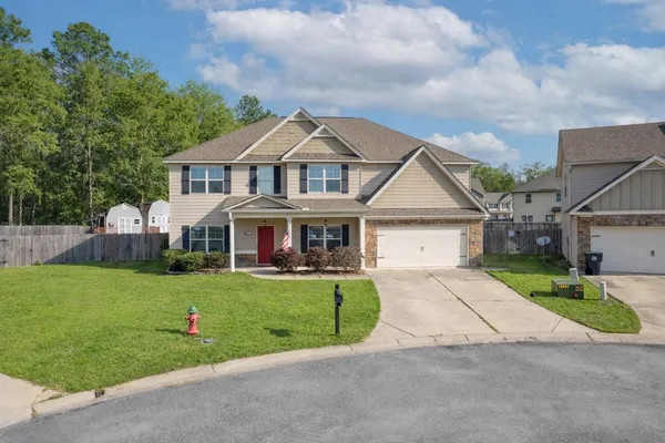 a front view of a house with a yard and garage